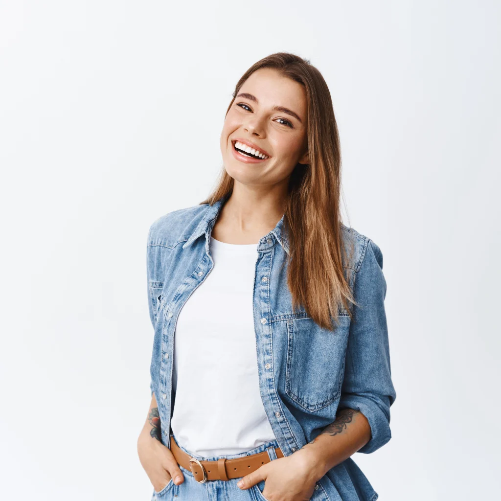 Happy woman smiling with hands in her pockets